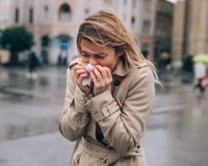 woman blowing her nose